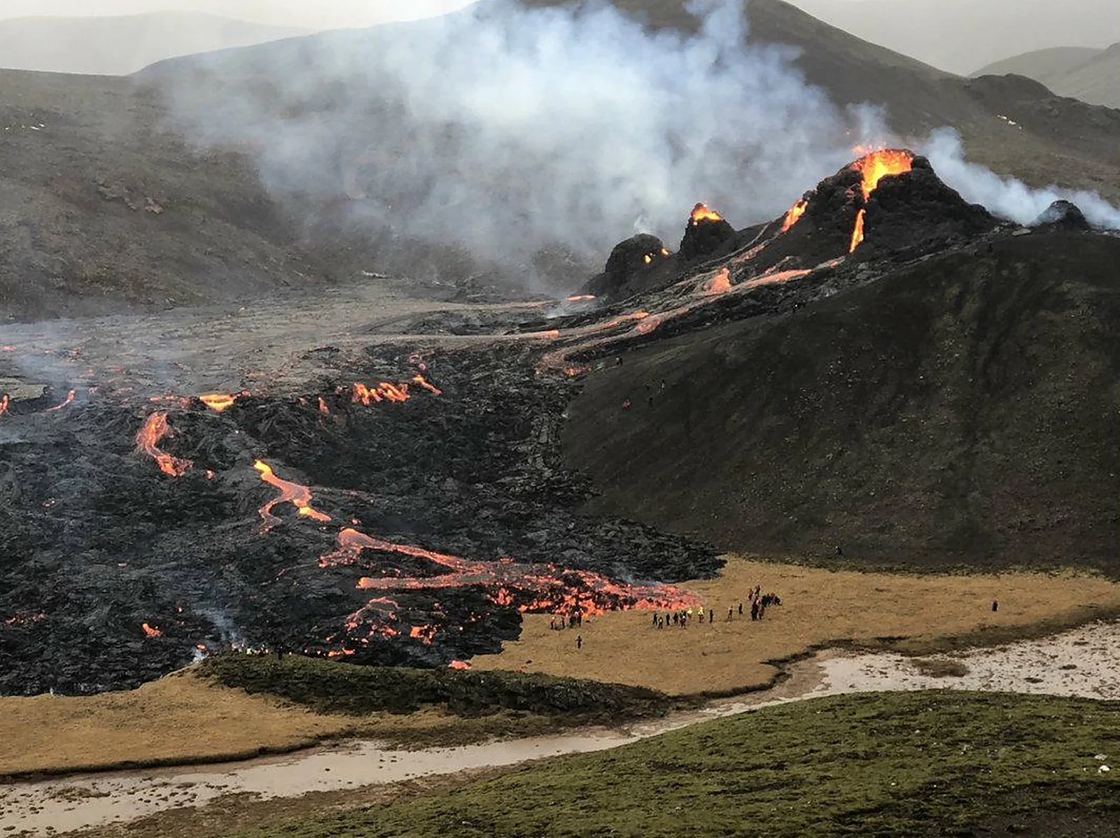 Fagradalsfjall eruption with lava flows and onlookers